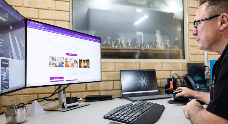 Pictured: Employer looking at the Skilled Migrant Employment Register on his desktop computer.