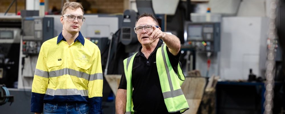 Building and Construction employer giving his new skilled migrant employee a tour of the workshop.