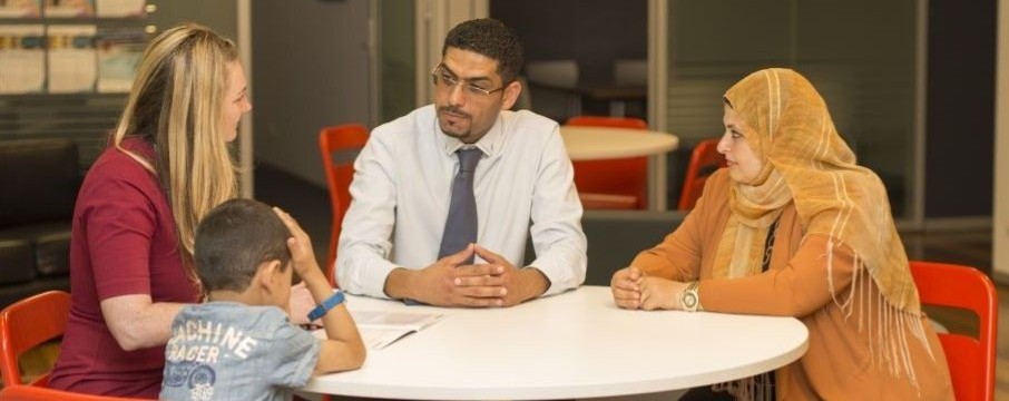 Pictured: Migration Services representative with skilled migrant family.