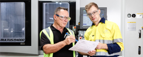 Two workers in protective gear on a worksite