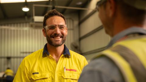 A man in a HI-VIS Jacket looking into camera